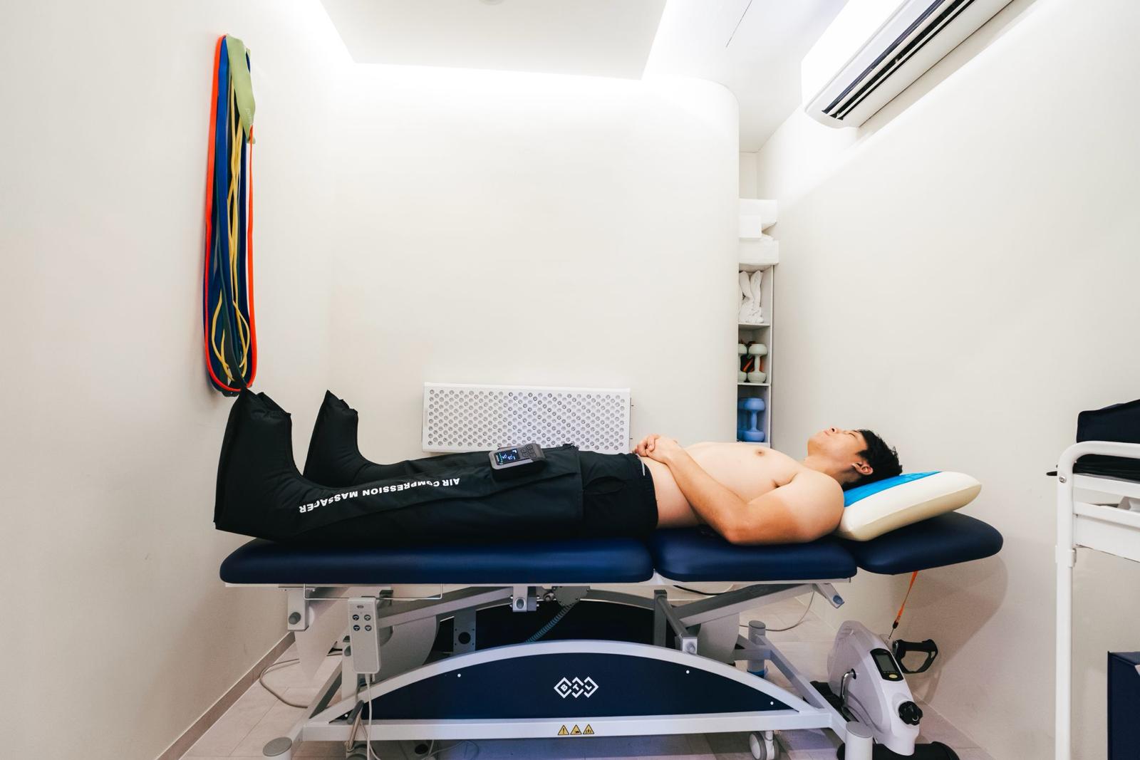 Client relaxing in air compression boots