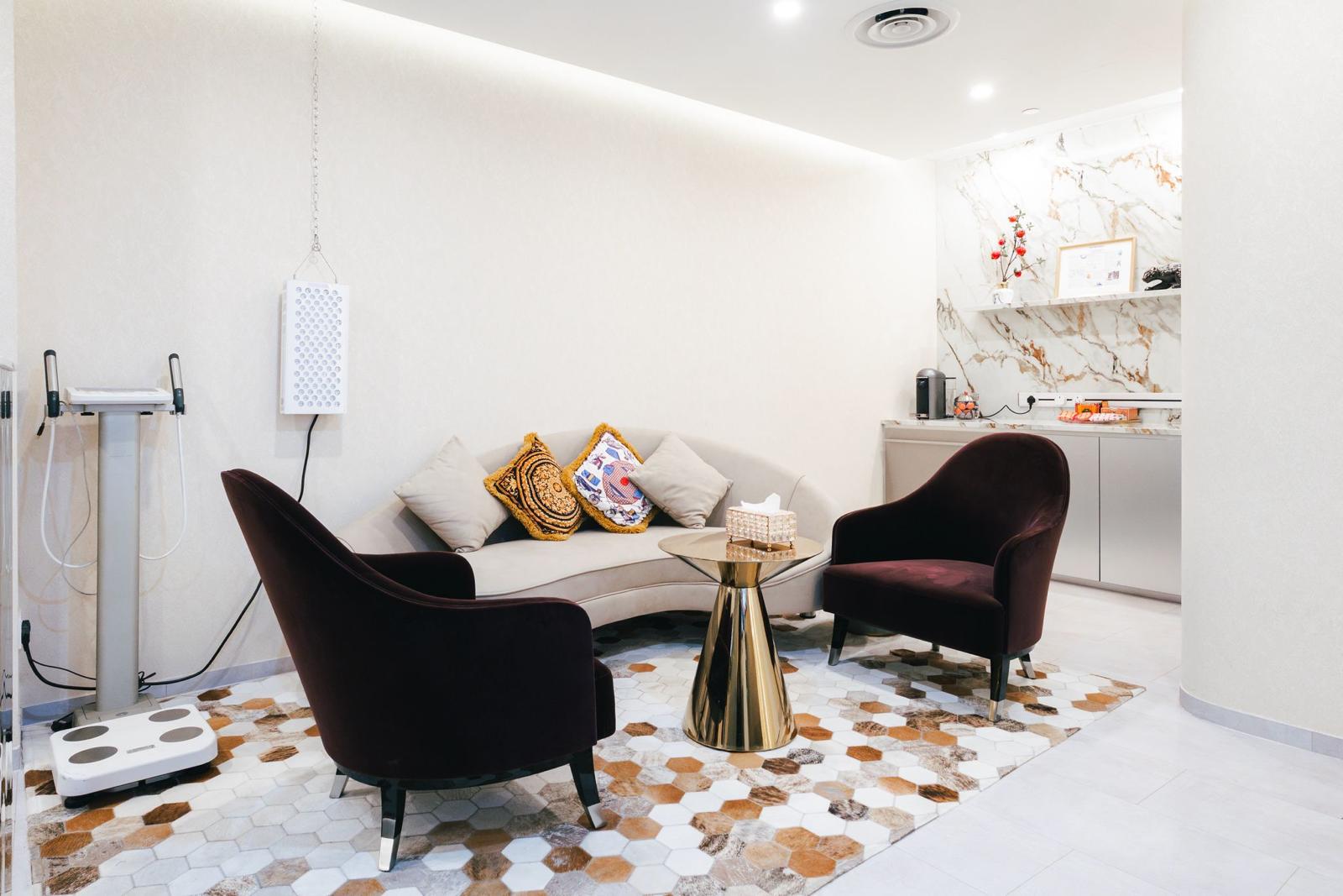 Consultation lounge with velvet armchairs and a curved sofa